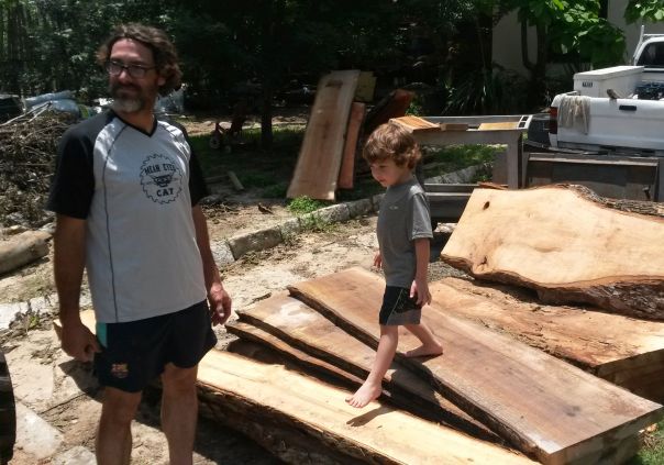 Daniel and his best little helper taking a break from harvesting fine lumber from fallen trees.